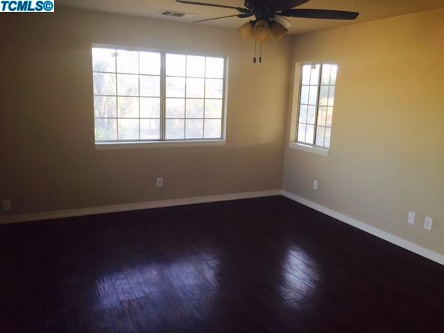 355 South Cornucopia Road Exeter, CA 93221 - Photo 12 of 26 a view of an empty room with wooden floor and a window