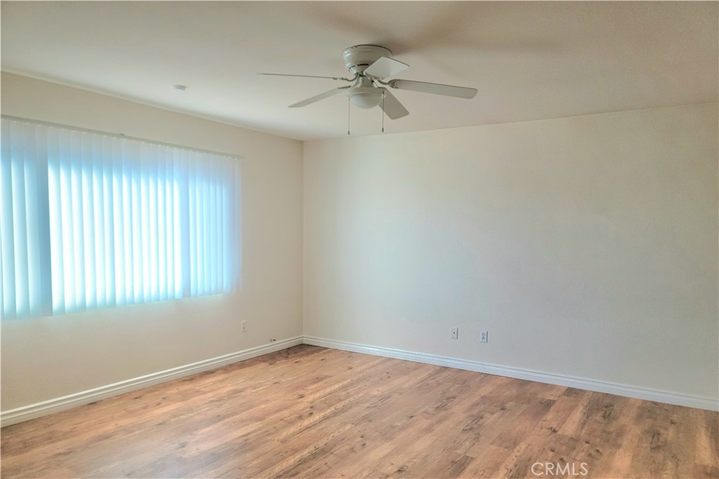 11729 Cliffwood Road Victorville, CA 92392 - Photo 4 of 8 an empty room with a window and a ceiling fan