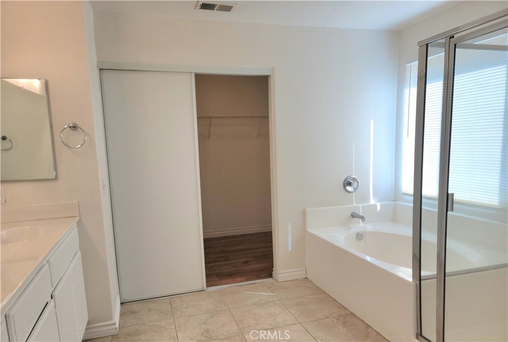 11729 Cliffwood Road Victorville, CA 92392 - Photo 6 of 8 a bathroom with a bathtub and a shower