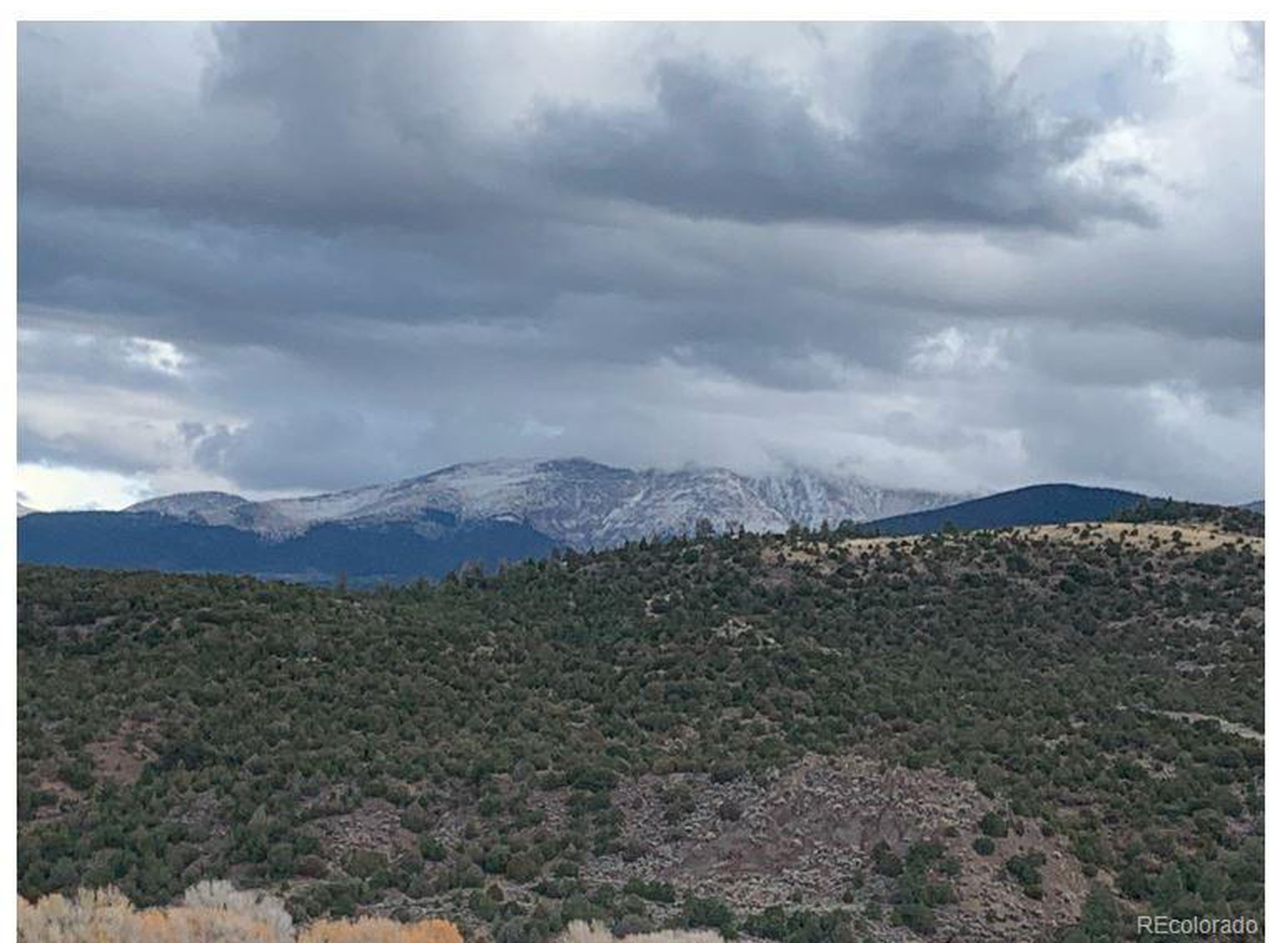 8 Mountain Ridge Lane San Luis, CO 81152 - Photo 11 of 28 a view of a dry yard with mountains in the background