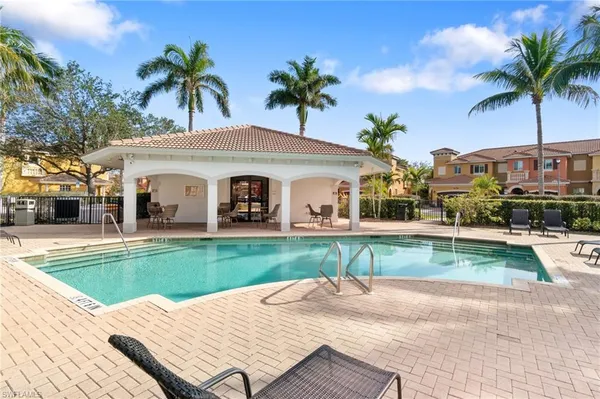 a view of a house with a swimming pool and a chair