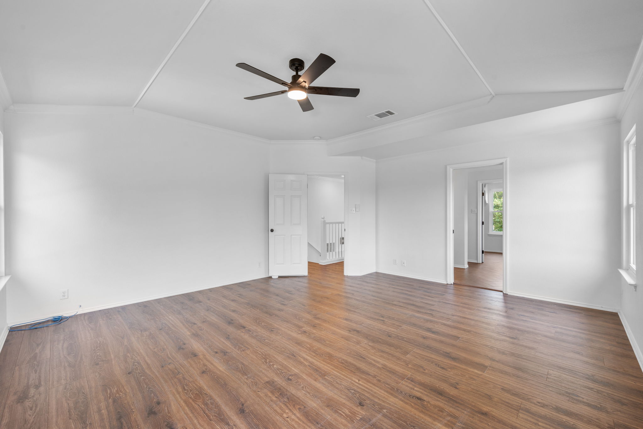 2440 Madeline Loop Cedar Park, TX 78613 - Photo 17 of 33 Unfurnished bedroom featuring crown molding, dark wood-style flooring, and a ceiling fan