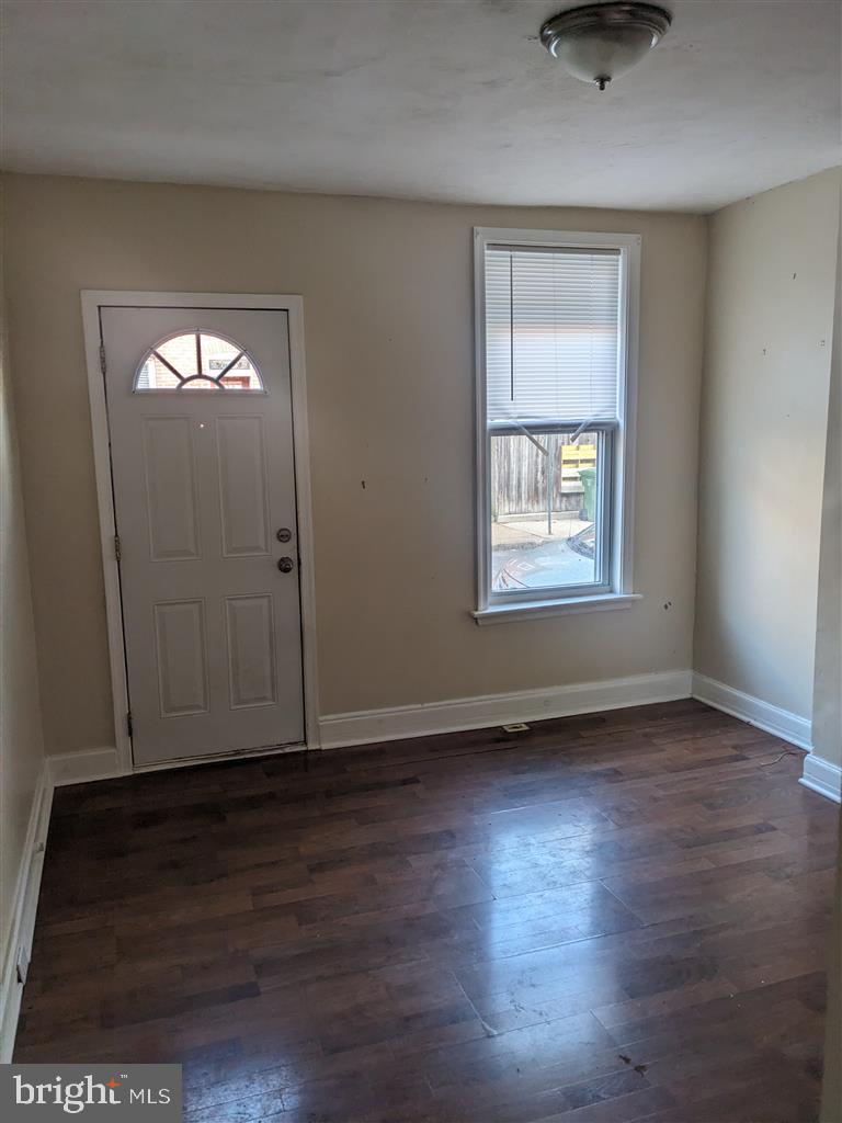 1622 Patapsco Street Baltimore, MD 21230 - Photo 2 of 6 an empty room with wooden floor and windows