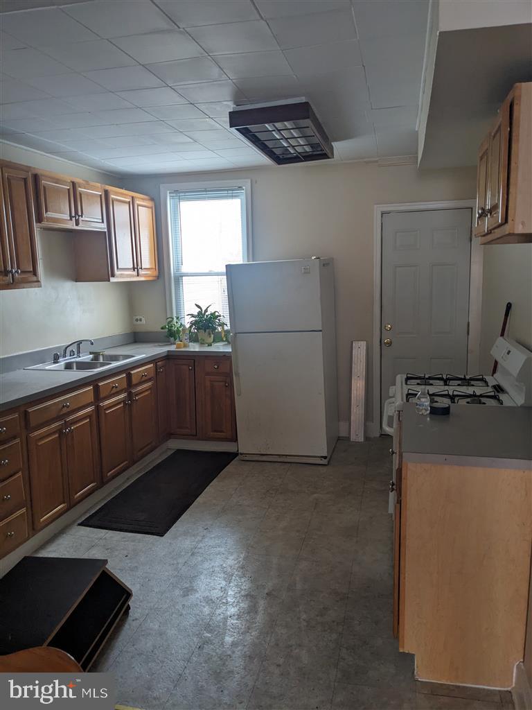 1622 Patapsco Street Baltimore, MD 21230 - Photo 5 of 6 a kitchen with a sink stove and cabinets
