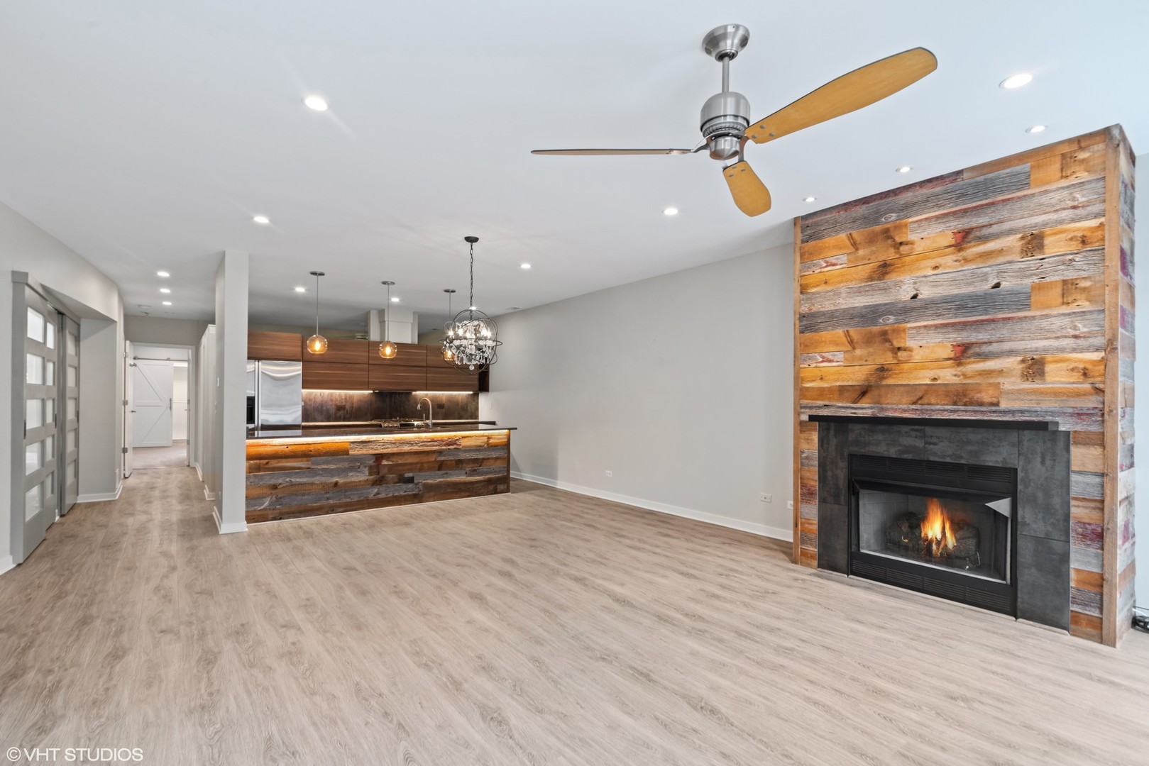 26 North May Street, Unit 322 Chicago, IL 60607 - Photo 11 of 31 a room with kitchen island a fireplace and wooden floor