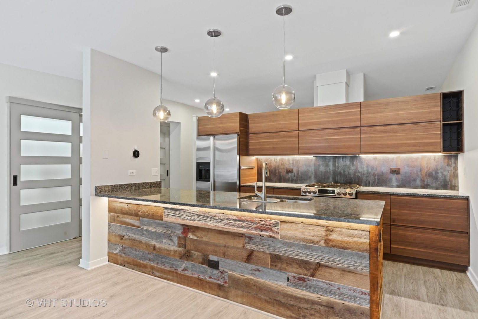 26 North May Street, Unit 322 Chicago, IL 60607 - Photo 16 of 31 a kitchen with kitchen island a counter top and stove top oven