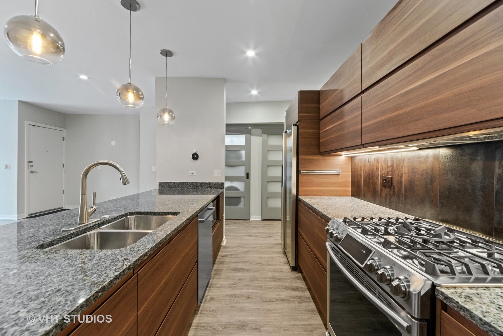 26 North May Street, Unit 322 Chicago, IL 60607 - Photo 17 of 31 a kitchen with granite countertop a sink stainless steel appliances and cabinets