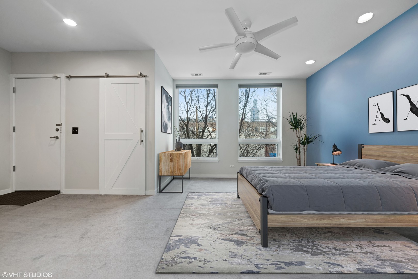 26 North May Street, Unit 322 Chicago, IL 60607 - Photo 20 of 31 a bedroom with a large bed and a chandelier