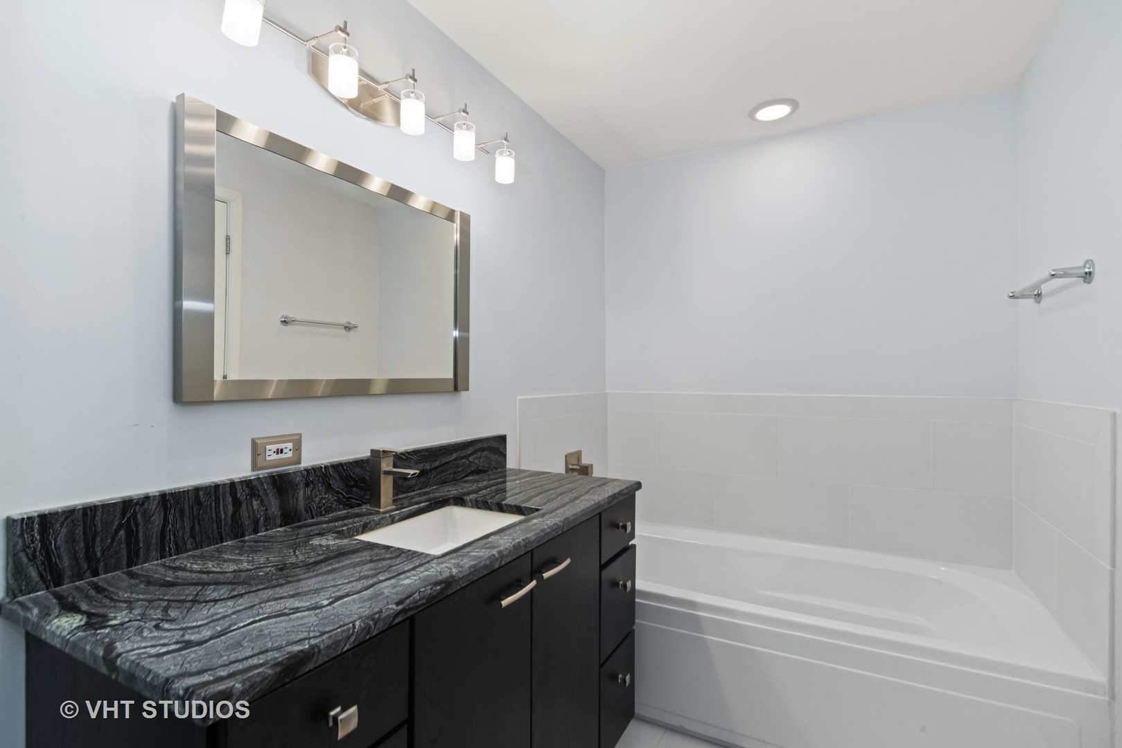 26 North May Street, Unit 322 Chicago, IL 60607 - Photo 24 of 31 a bathroom with a granite countertop sink a toilet and bathtub