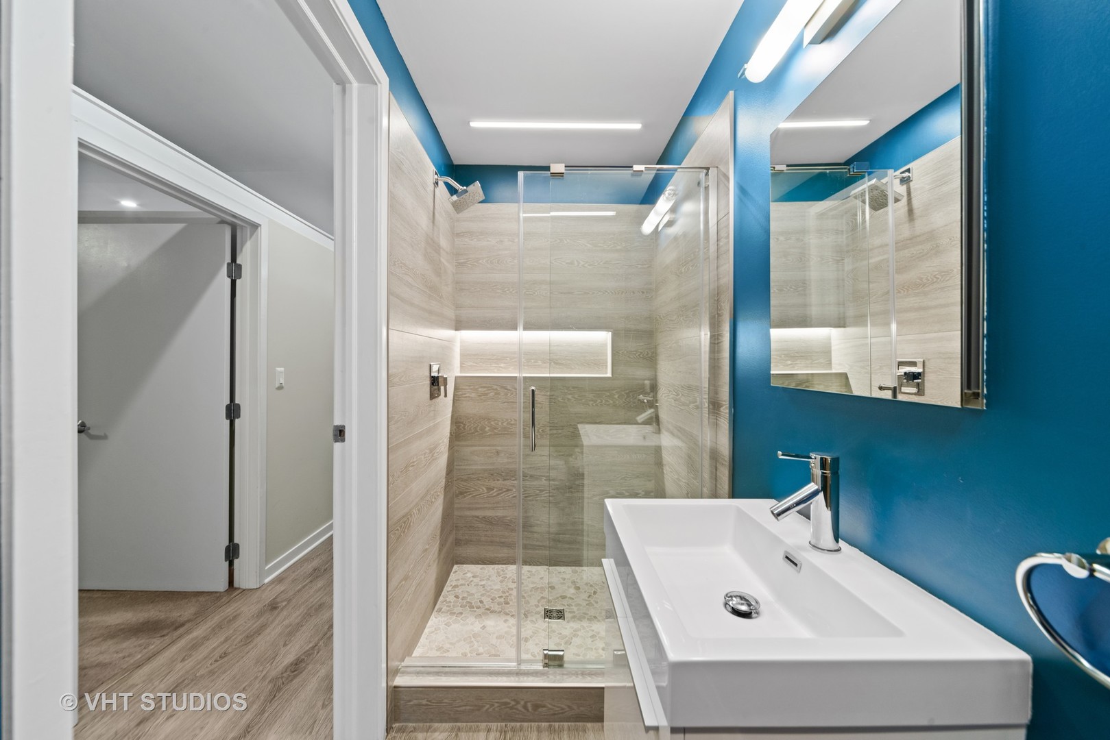26 North May Street, Unit 322 Chicago, IL 60607 - Photo 27 of 31 a bathroom with a sink and mirror