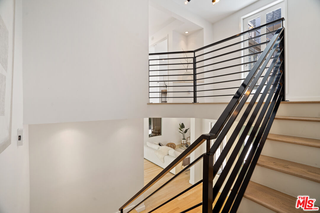 373 Mesa Road Santa Monica, CA 90402 - Photo 11 of 25 a view of a hallway with wooden floor and stairs