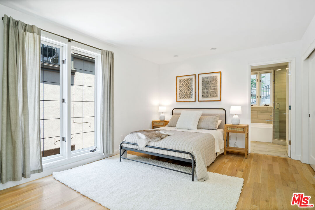 373 Mesa Road Santa Monica, CA 90402 - Photo 15 of 25 a bedroom with a bed wooden floor and window