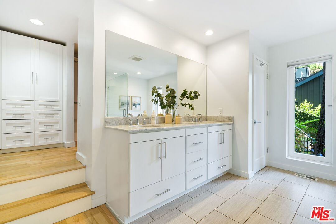 373 Mesa Road Santa Monica, CA 90402 - Photo 20 of 25 a spacious bathroom with a shower a sink and a mirror