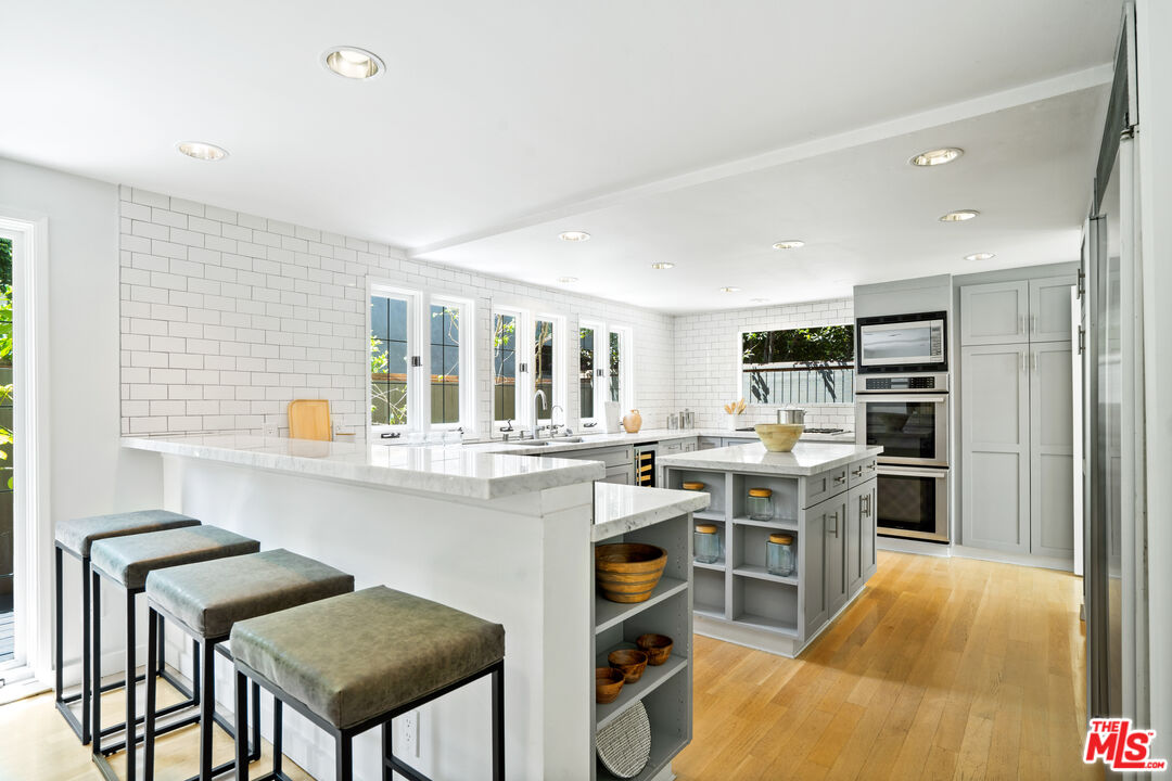 373 Mesa Road Santa Monica, CA 90402 - Photo 6 of 25 a kitchen with cabinets and chairs