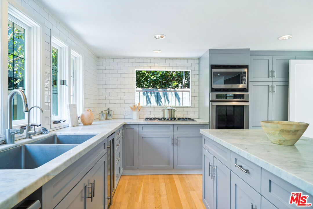 373 Mesa Road Santa Monica, CA 90402 - Photo 7 of 25 a kitchen with stainless steel appliances granite countertop a sink and a stove