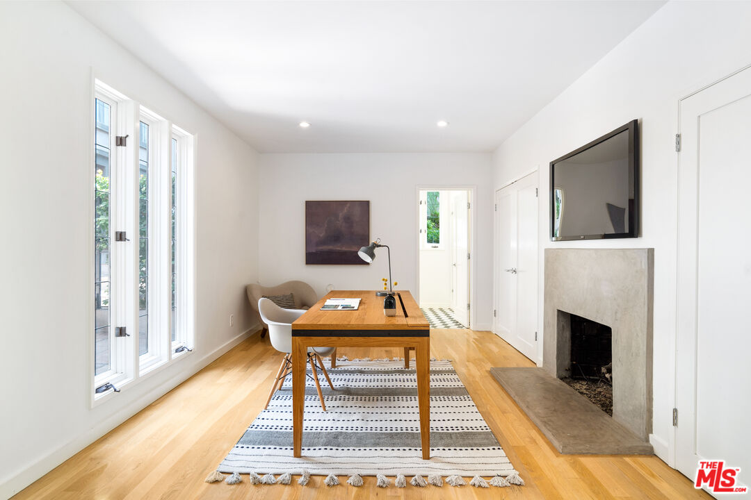 373 Mesa Road Santa Monica, CA 90402 - Photo 9 of 25 a living room with furniture a flat screen tv and a fireplace