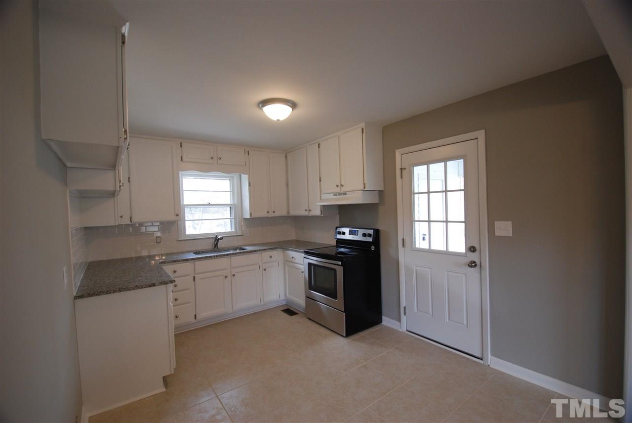 6408 Rock Quarry Road Raleigh, NC 27610 - Photo 7 of 22 Custom tile floor, new appliances, new granite counter tops, new hardware on freshly painted cabinets, dishwasher added to home.