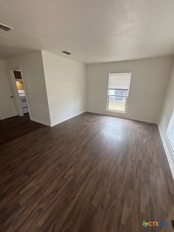 1206 Middleton Street Killeen, TX 76541 - Photo 2 of 6 an empty room with wooden floor and windows