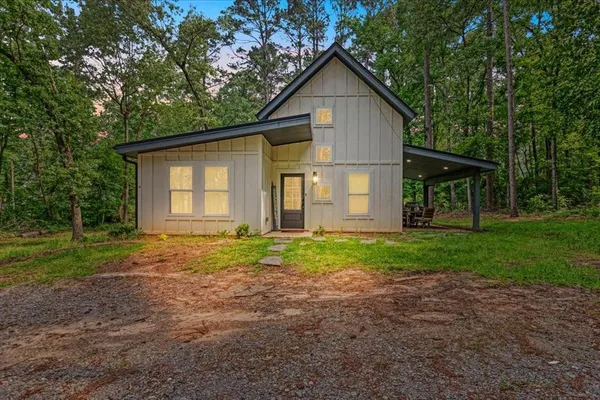a view of a house with yard and tree s