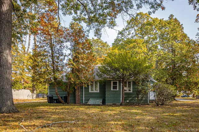 a house that has a tree in front of it
