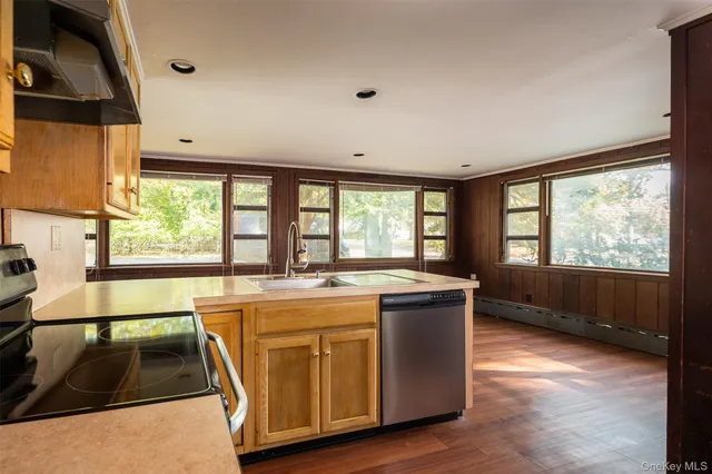 a view of a kitchen with a sink and large window