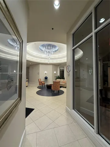 a view of a hallway with livingroom and furniture
