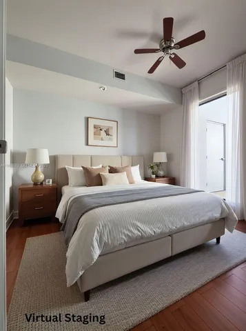 a bedroom with a large bed and a ceiling fan