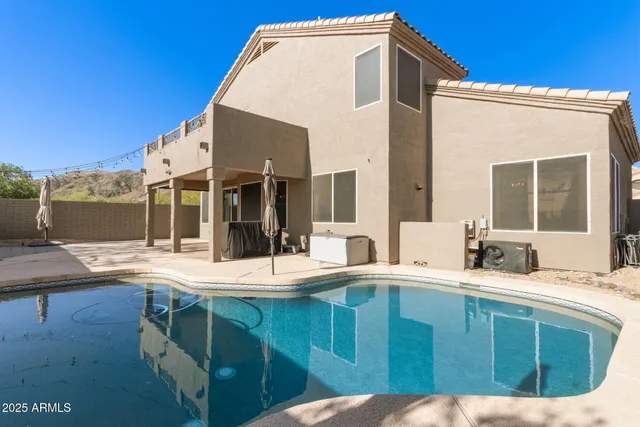 a view of a swimming pool with a yard