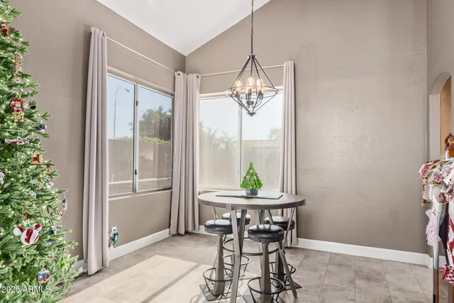 a view of a dining room with a table and chairs