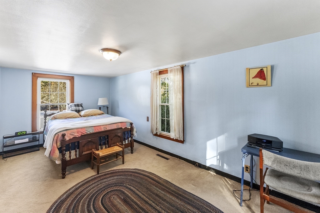 115 Kennedy Road Stoughton, MA 02072 - Photo 21 of 42 a bedroom with a bed a chandelier and a dresser