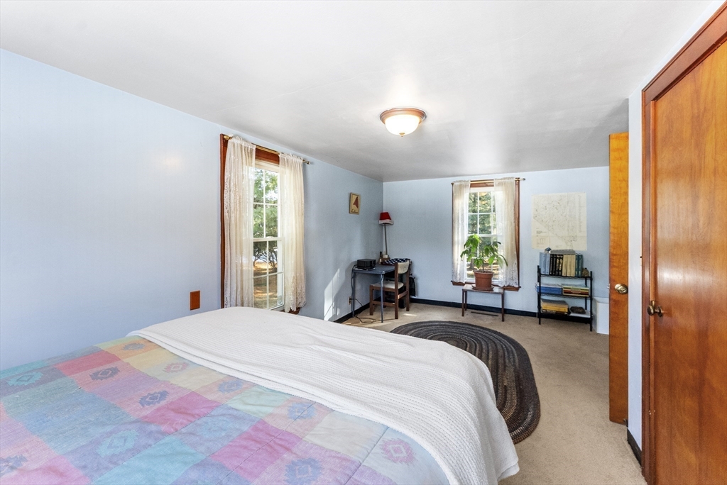115 Kennedy Road Stoughton, MA 02072 - Photo 22 of 42 a bedroom with a bed and large windows