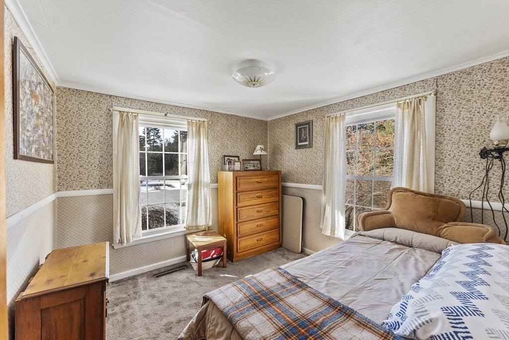 115 Kennedy Road Stoughton, MA 02072 - Photo 23 of 42 a bedroom with a bed and wooden floor