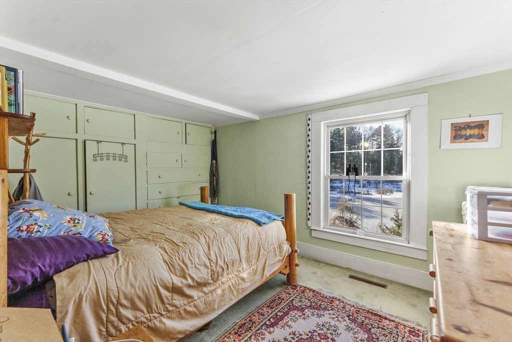 115 Kennedy Road Stoughton, MA 02072 - Photo 25 of 42 a bedroom with a bed and a window