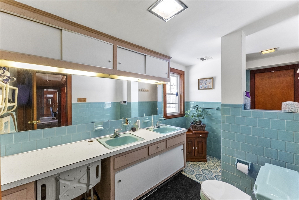 115 Kennedy Road Stoughton, MA 02072 - Photo 27 of 42 a bathroom with a sink mirror and toilet