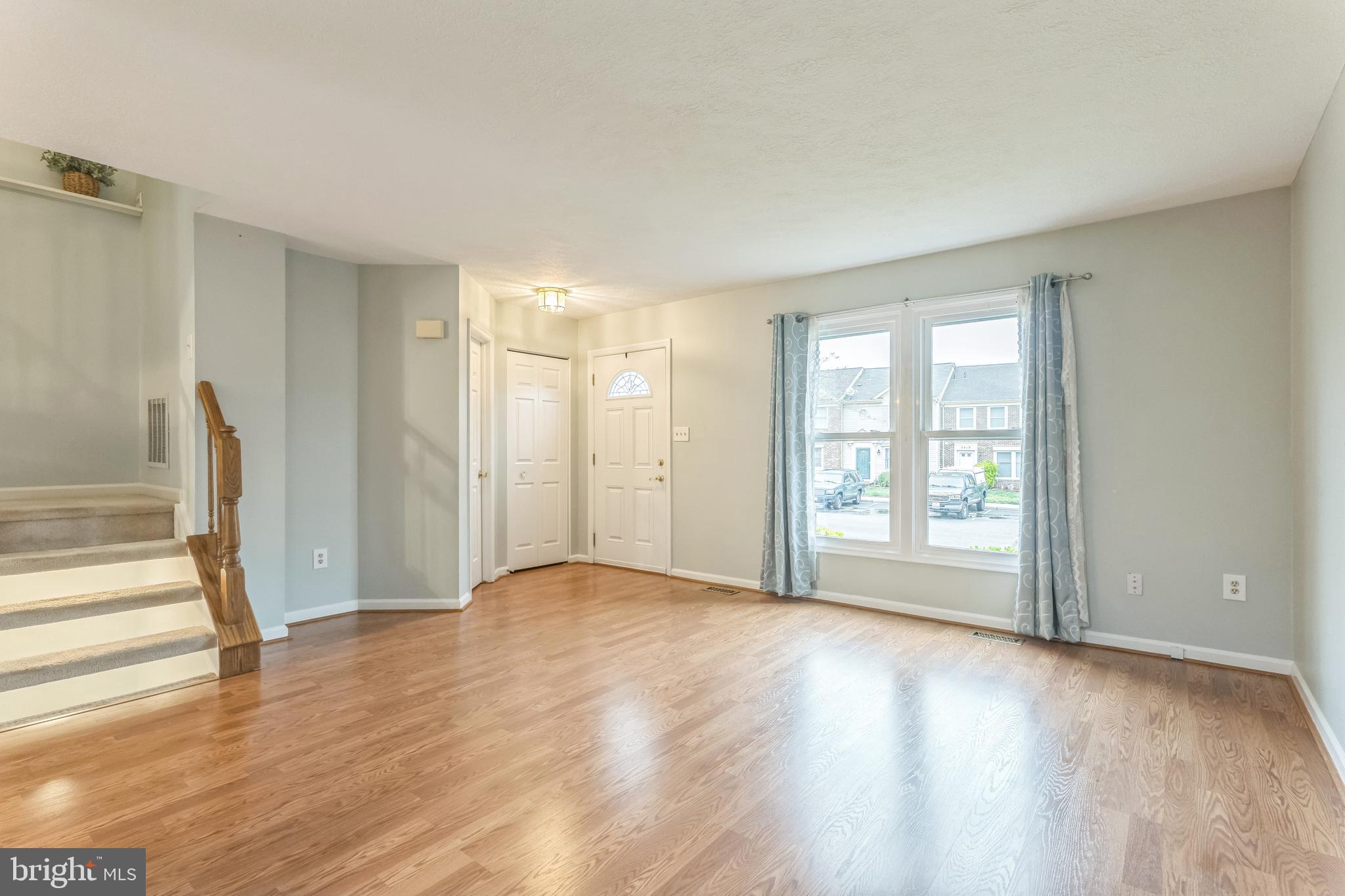 5620 Denton Court Frederick, MD 21703 - Photo 2 of 33 a view of an empty room with wooden floor and a window