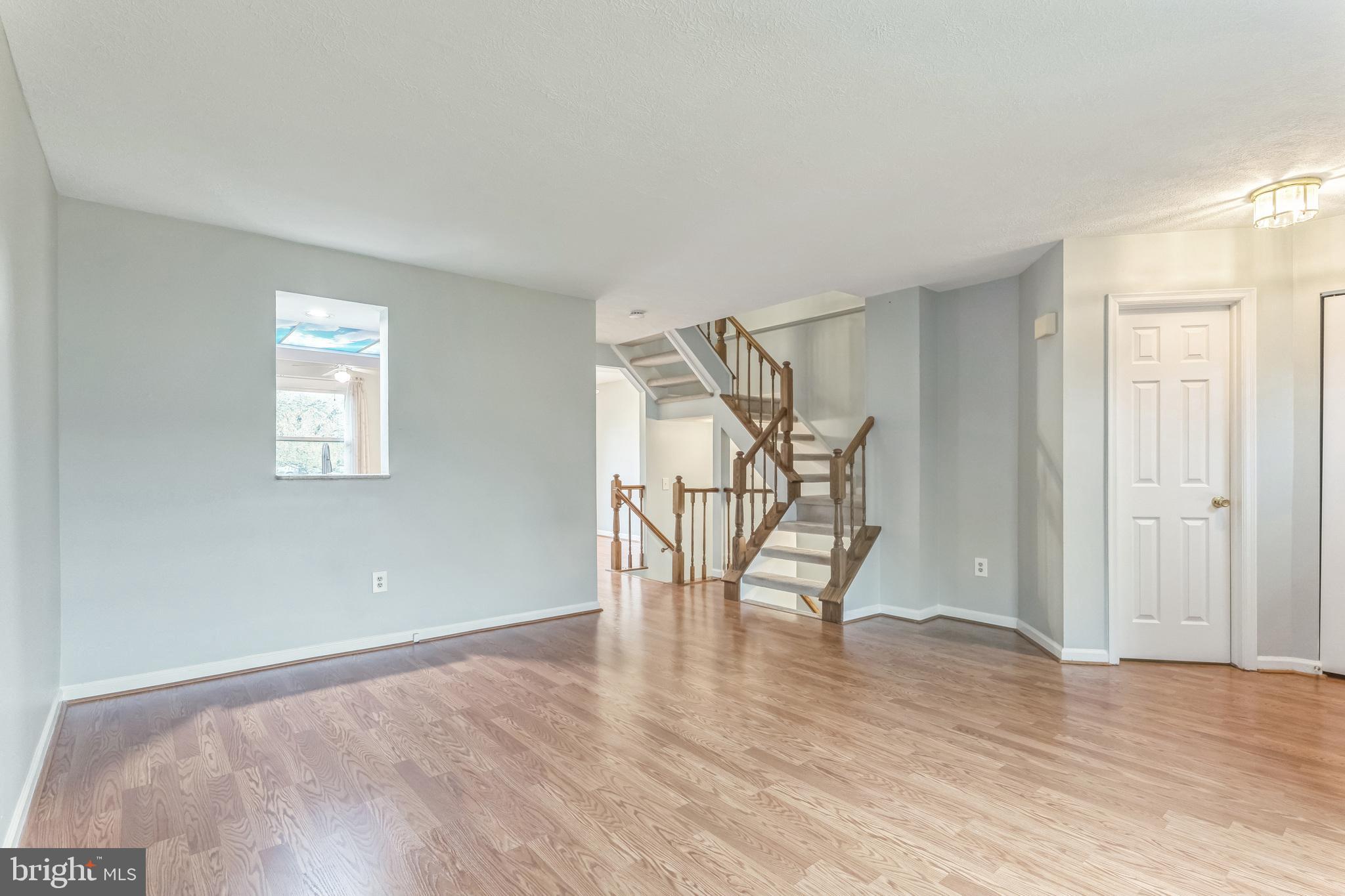 5620 Denton Court Frederick, MD 21703 - Photo 4 of 33 an empty room with wooden floor and windows