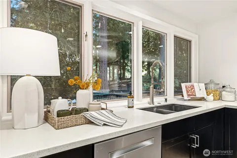 a large kitchen with a table and chairs