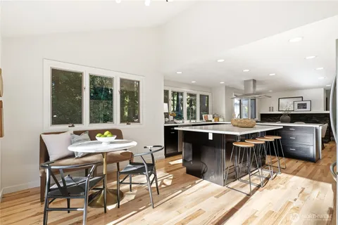 a living room with furniture fireplace and a large window