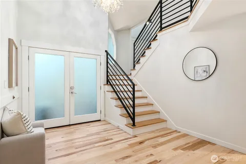a view of a livingroom with wooden floor and stairs