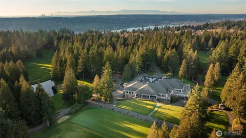 an aerial view of a house with swimming pool and porch