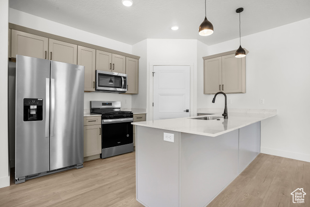 1631 West Century Lane, Unit B Mapleton, UT 84664 - Photo 8 of 33 Kitchen featuring appliances with stainless steel finishes, pendant lighting, light stone counters, a peninsula, and light wood finished floors