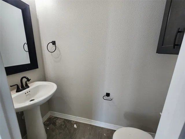 a bathroom with a sink a toilet and a mirror