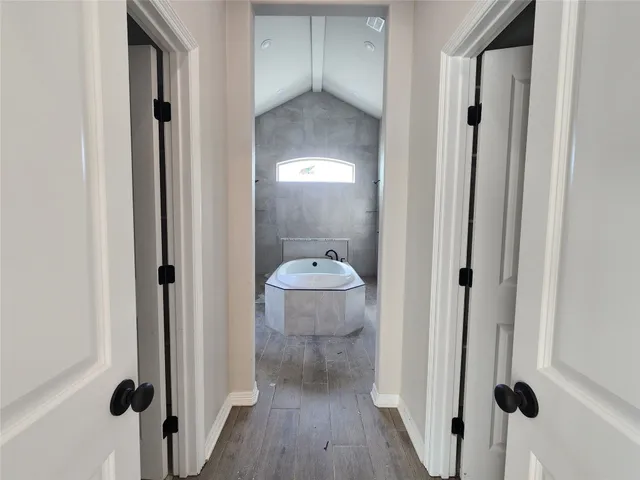 a view of a bathroom from a hallway