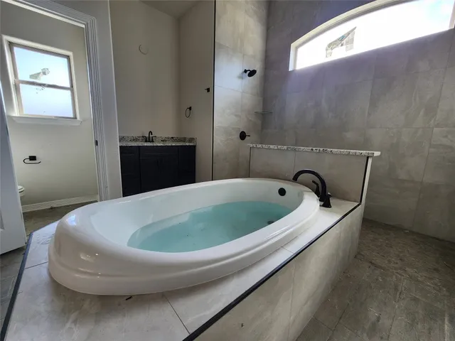 a white bath tub sitting in a bathroom