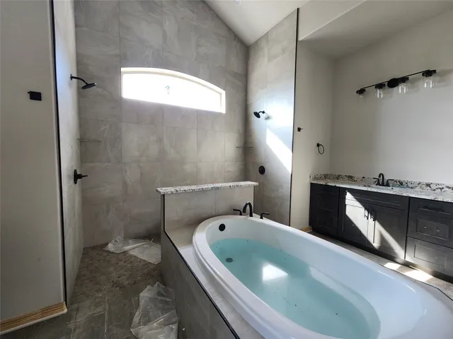 a bathroom with a tub a toilet and a sink