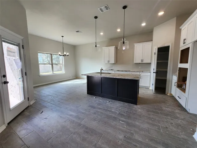 a large kitchen with stainless steel appliances granite countertop a stove and a sink