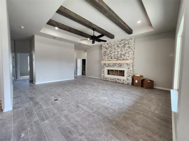 a view of a livingroom with an empty space and a fireplace