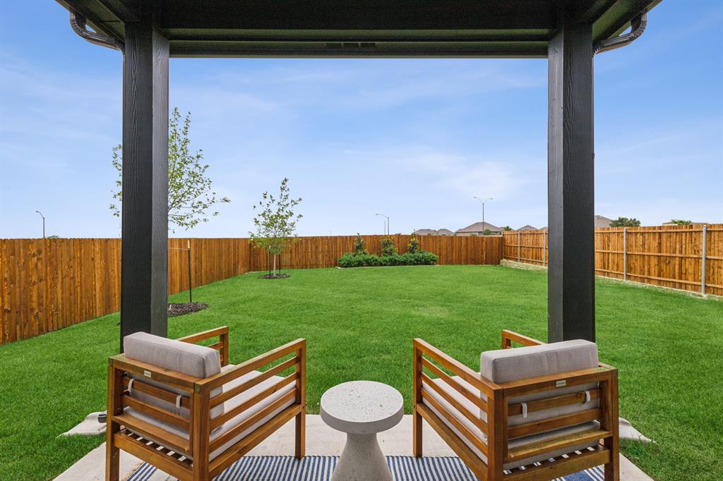9505 Rattlesnake Trail Crowley, TX 76036 - Photo 29 of 33 a backyard of a house with table and chairs