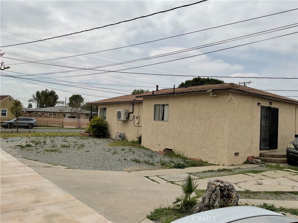5007 Astor Avenue Commerce, CA 90040 - Photo 11 of 64 a view of a house with a dirt road and a car parked side of it