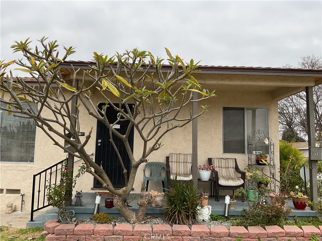 5007 Astor Avenue Commerce, CA 90040 - Photo 16 of 64 a front view of a house with garden